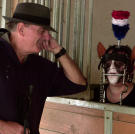 Pony play addict Nicole, waits in the horse stall for her handler to take her out for a walk.