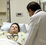 Dr. Nowzaradan visits Christina's bedside.