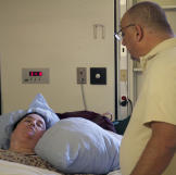 Penny's husband visits her after her surgery.