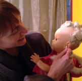 Cat incorporates her doll Volo into all aspects of her life.