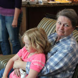 Grandma Sheryl (Janelle’s mom), holds Savanah on her lap.