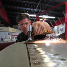 Pretty boy mechanic Jeff Thisted sands down a 1968 Camaro.