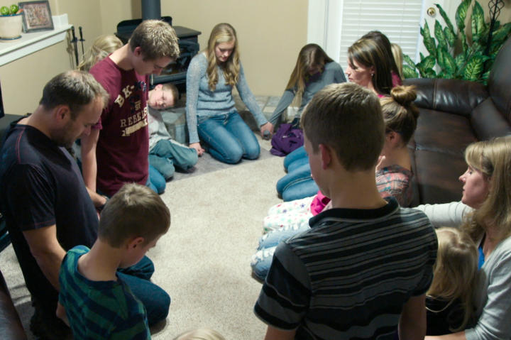 The family says a prayer together before mealtime.