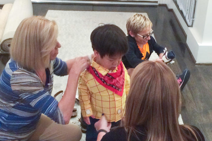 Jen's mom helps the kids get dressed for trick-or-treating. The concept was new to them, so they had to explain how it works.