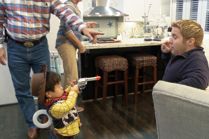 Stick 'em up, partner! Will shows off his costume and props to Bill. Check out