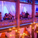 After the wedding ceremony, guests gathered in the loft area for cocktail hour. During that time, the main level of the venue was transformed from a ceremony to a reception setting.