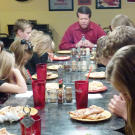 The Duggars give thanks for their meal.