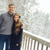 The happy couple poses in a winter wonderland. Derick proposed to Jill with a little songwriting help from