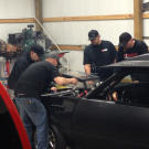 Tyler Priddy (a.k.a Flip), Justin Shearer (a.k.a. Big Chief), Shawn Ellington (a.k.a. Murder Nova) and Danny Parker work on a car together.