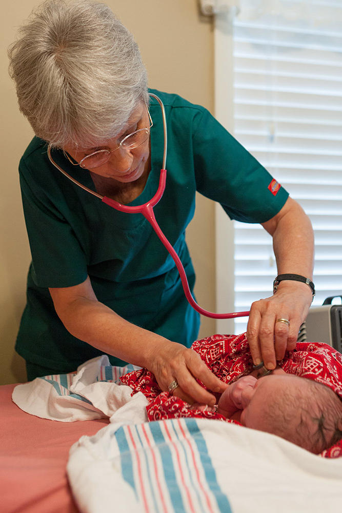 The midwife checks out Marcus.