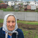 This gypsy elder poses against a concrete wall that separates Roma families from other residents of Ostrovany, eastern Slovakia.