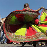 A Romany woman in downtown Prague, Czech Republic, dances during the World Roma Festival Khamoro.