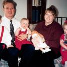 A younger Kody and Janelle take a family photo with their four children, Logan, Madison, Hunter and Garrison.