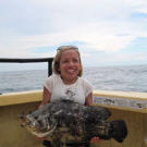 Jen holds a big one she caught while deep sea fishing off the coast of central Florida. You don't need height to reel in a fish like that, just muscle and determination.