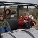 Zach, Molly and Matt ride a golf cart around the family's property in Oregon.