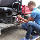 Jeremy Roloff, one of the twins, fixes a tractor. As one of the oldest and tallest members of the Roloff family, it is his job to drive the tractors filled with pumpkin seekers each fall.