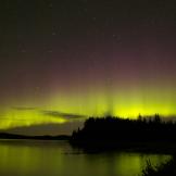 A starry sky tinted with the purple and yellow hues.