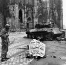 Cpl. Luther E. Boger of the 82nd Airborne Division reads a warning sign. The street leads to the Rhine River and was under observation of the Germans who occupied a stronghold there, April 1945.
Watch video of the