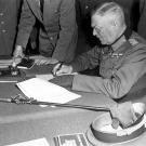 Looking every part the German military bad guy, Field Marshall Wilhelm Keitel signs the unconditional surrender of the German Army at the Soviet headquarters in Karlshorst, Berlin, May 8th, 1945. Keitel would suffer the same fate as Jodl at Nuremberg.