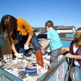 Joanie Demer dumpster dives for coupons with her son and friend.