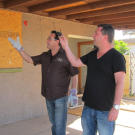 Diamond in the rough? Scott Menaged and Lou Amoroso inspect a back patio that's in need of a renovation.