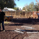 Steve Simons talks to an animal handler while Ed Rosenberg herds chickens in the background. It's not unusual for previous owners to leave behind strange items when they move out.