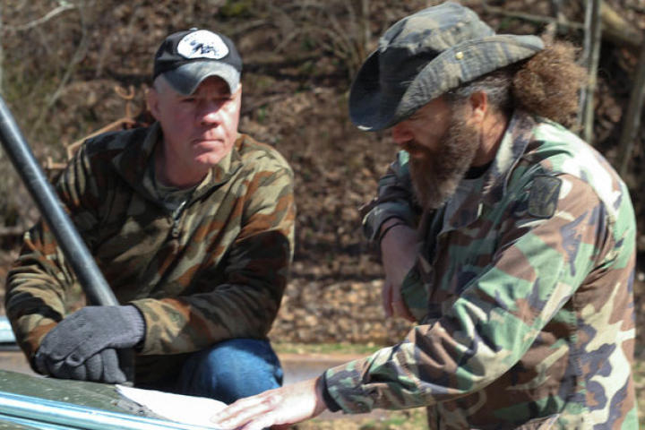 Wild Bill (left) and Willie go over plans for one of their traps.