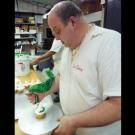 Mauro pipes green butter cream onto Christmas Tree cupcakes.