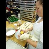 Lauren pipes white icing onto some Christmas cupcakes.