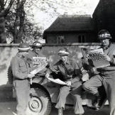 Four MPs take a break along a German road to read the best headline to date in the