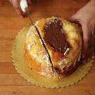 Start by filling your 8-inch Bundt cake with Buddy's Chocolate Fudge Frosting. Then, cut the cake at one edge where the central hole meets the cake.