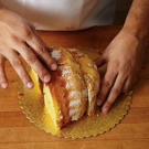 Now, turn the larger piece of cake frosting side down, and put the piece you sliced off beside it. This is the shape of your turkey.