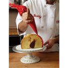 It's time to start piping your plumage! Using a pastry bag fitted with the #126 rose tip, start with your red Decorator's Buttercream. Pipe the red buttercream around the high, open end of the turkey in a ruffle pattern.