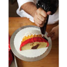Now, add a ruffled ring of black buttercream, overlapping slightly with the red ring.