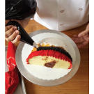 Continue to pipe the black ring around the entire diameter of the turkey cake.
