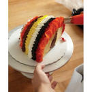 After the front of your cake is done, it's time to cover the open back end. Create the same ruffled, colorful rings in the back.