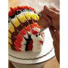Add a little red buttercream under the turkey's throat, and use black buttercream to give the turkey eyes.