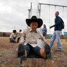 Joel comes down the slide in his cowboy boots at the Dude Ranch.