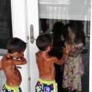 Covered in pudding, Aaden and Joel look in at Hannah. She doesn't seem very happy.