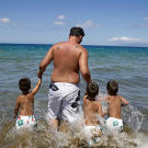 Jon takes the boys into the ocean in Maui.