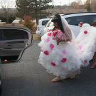 Louann gathers her full, floral skirt with a little help.