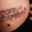 "Do you suppose she's a wildflower" is a quote from Alice in Wonderland, tattoo by Megan Massacre,