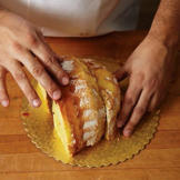 Now, turn the larger piece of cake frosting side down, and put the piece you sliced off beside it. This is the shape of your turkey.