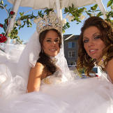 Nettie's dress is so enormous, she and her maid of honor can barely squeeze into this carriage together!