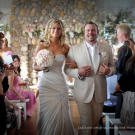 Flower arrangements included centerpieces made with crystal trumpet vases filled with willow branches and Hawaiian dendrobium orchids and roses, a lush floral archway of roses, hydrangea and orchids, and two giant trees dripping with orchid lai's and crystals.