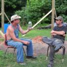 Tim shows off a jar of moonshiner to Tickle.