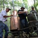 Jeff, Jim Tom and Mark fix a still out in the woods.