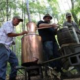 Jeff, Jim Tom and Mark fix a still out in the woods.