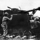 1944 - A wrecked German tank. Notice its "Bazooka Pants," meant as a defense against rockets.
Watch video of the