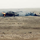Still burning, these two Iraqi T-55 main battle tanks were damaged by a Coalition attack near the Kuwait border during Operation Desert Storm. The rear tank was attempting to tow the other one, as evidenced by the cable linking them, February 1991.
Watch
